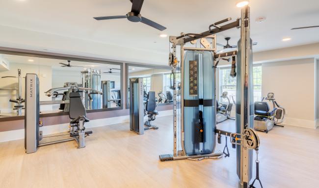 Enjoy our resident-only features The fitness center at Arden at Huntersville senior living apartments in Charlotte, NC, featuring weight lifting machines.