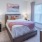 a bedroom with a bed and a fan
