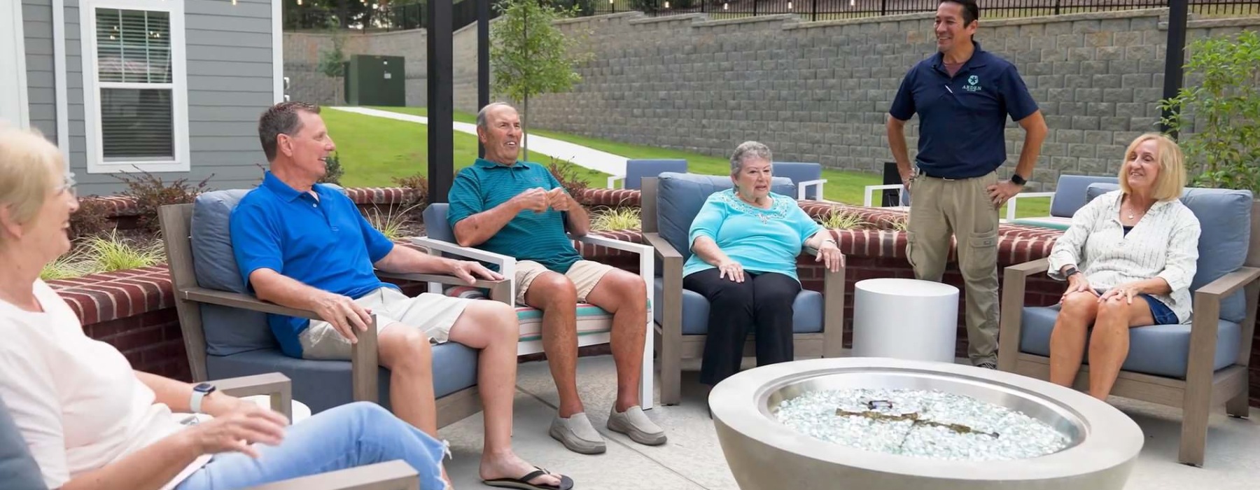 a group of people sitting around a fireplace