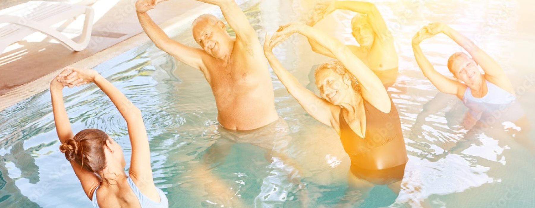 people in a pool doing synchronized swimming