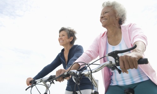 Two senior women riding bikes