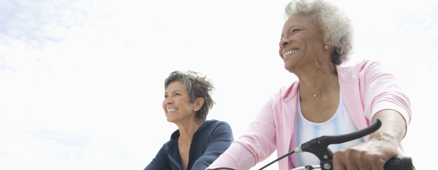 Two senior women riding bikes
