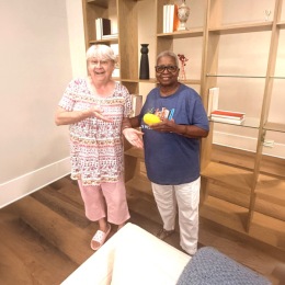 two women indoors by some wooden decor