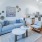 a living room with a blue couch and a white table