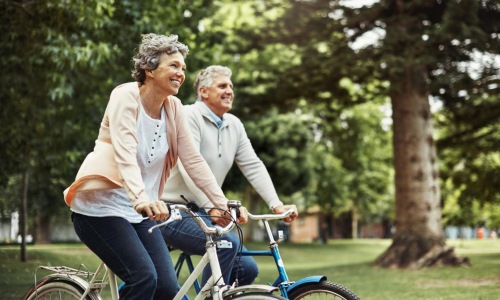 Find your perfect fit at Arden at Huntersville a man and a woman riding a bicycle