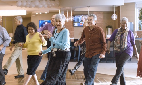 a group of people line dancing