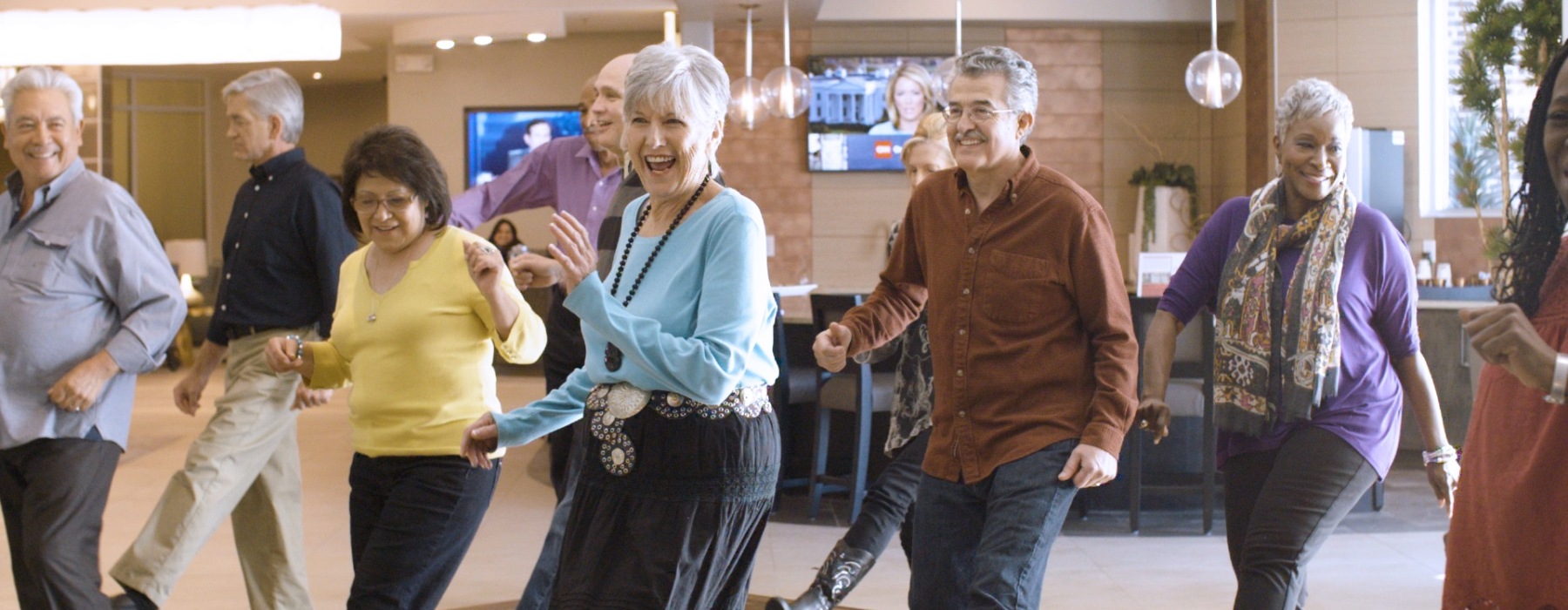 a group of people line dancing