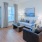 Model living room at Arden at Huntersville senior living apartments in Charlotte, NC, featuring wood grain floor paneling.