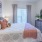 a bedroom with a bed and a fan