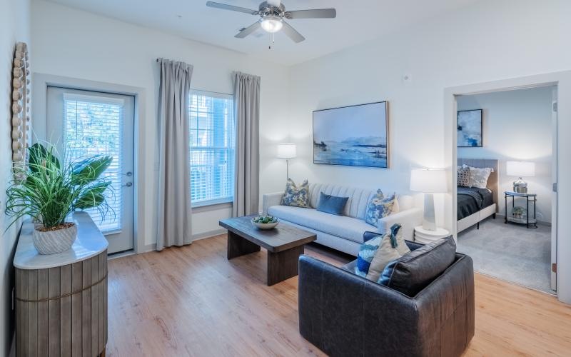 a living room with a couch and a fan