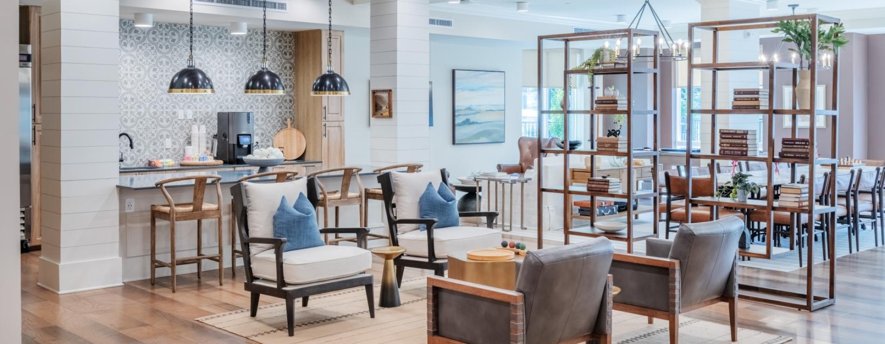 Resident lounge at Arden at Huntersville senior living apartments in Charlotte, NC, featuring wood grain floor paneling.